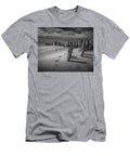 Footprints and Pilings on the Beach in Black and White Randall Nyhof T-Shirt