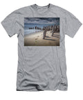 Footprints and Pilings on the Beach Randall Nyhof T-Shirt